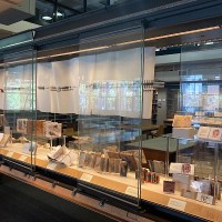 Display case with books and birdsong prints